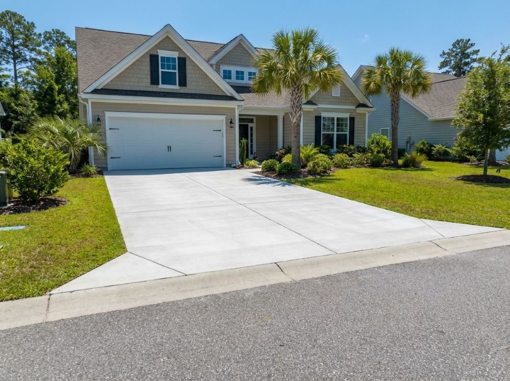 Completed concrete driveway in front of a home in Carolina Forest
