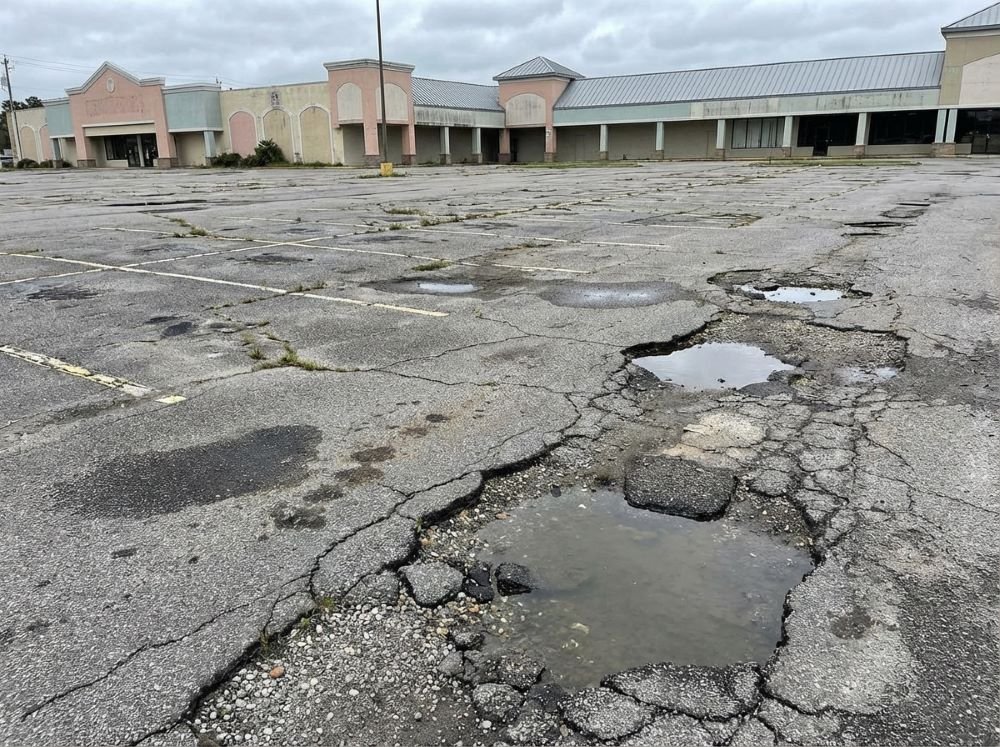 Damaged parking lot before resurfacing in North Myrtle Beach