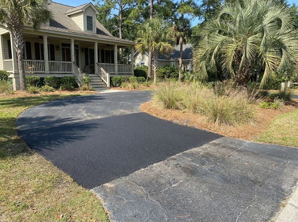 Finished blacktop patch repair flush with surrounding surface